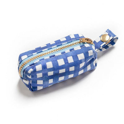 Side view of fabric rectangular pouch with zip closure and snap loop for poop bags in navy watercolor plaid