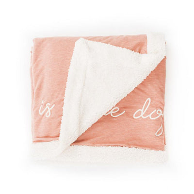 Blush fleece blanket with The Doggy Snuggle is Real embroidered on front and natural Sherpa back side folded with corner back