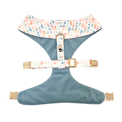 Back/top side of reversible dog harness in dusty blue velvet and polka dot print.