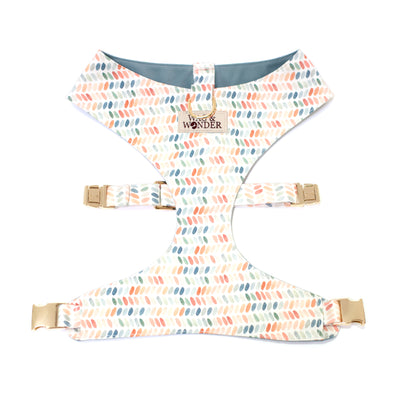 Reversible dog harness in dot prints of blues, terra cottas, and greens.