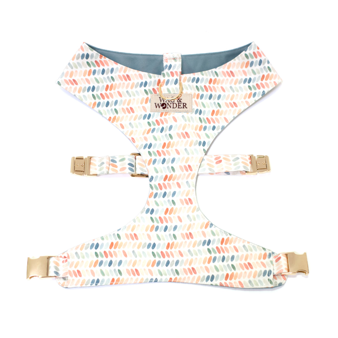 Polka dot reversible dog harness with gold hardware.