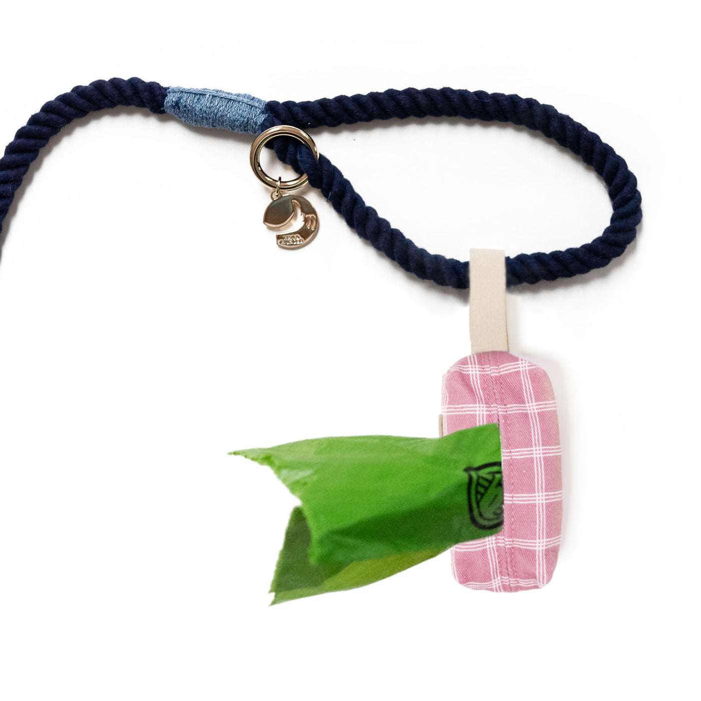 Bottom view of pink plaid dog poop bag holder attached to leash handle