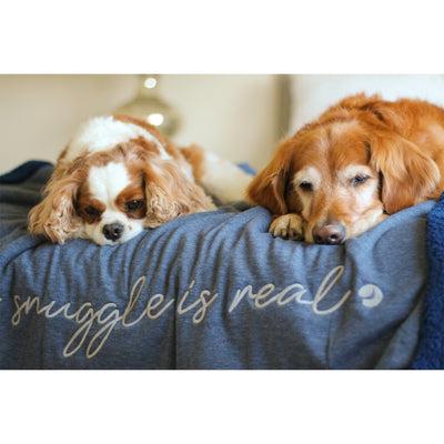 Cavalier King Charles Spaniel and Golden Retriever snuggling on a navy dog blanket reading snuggle is real in embroidery