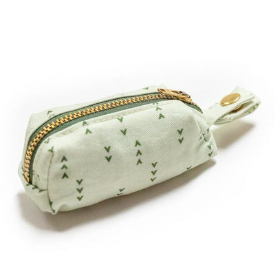 Side view of fabric rectangular pouch with zip closure and snap loop for poop bags in light green with dark green arrows
