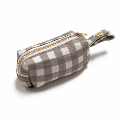 Side view of fabric rectangular pouch with zip closure and snap loop for poop bags in gray buffalo check