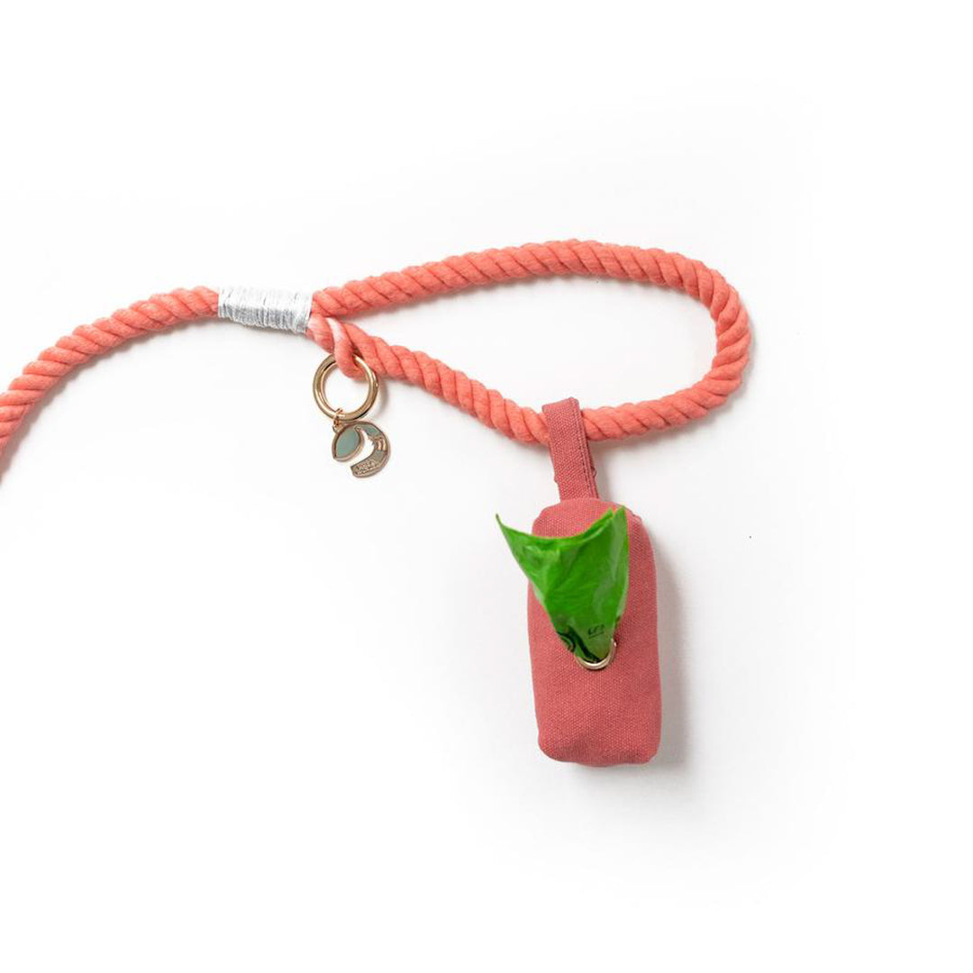 Coral fabric pouch dog poop bag holder attached to rope leash with snap closure loop to handle of rope dog leash