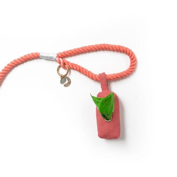 Coral fabric pouch dog poop bag holder attached to rope leash with snap closure loop to handle of rope dog leash
