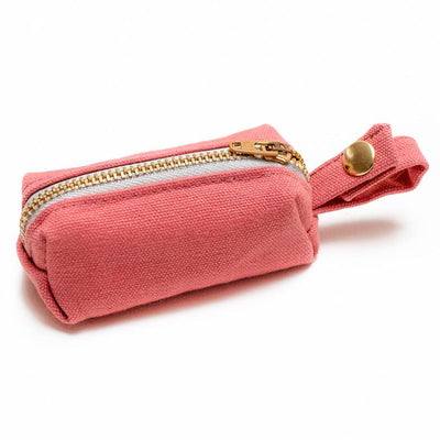 Side view of fabric rectangular pouch with zip closure and snap loop for poop bags in coral