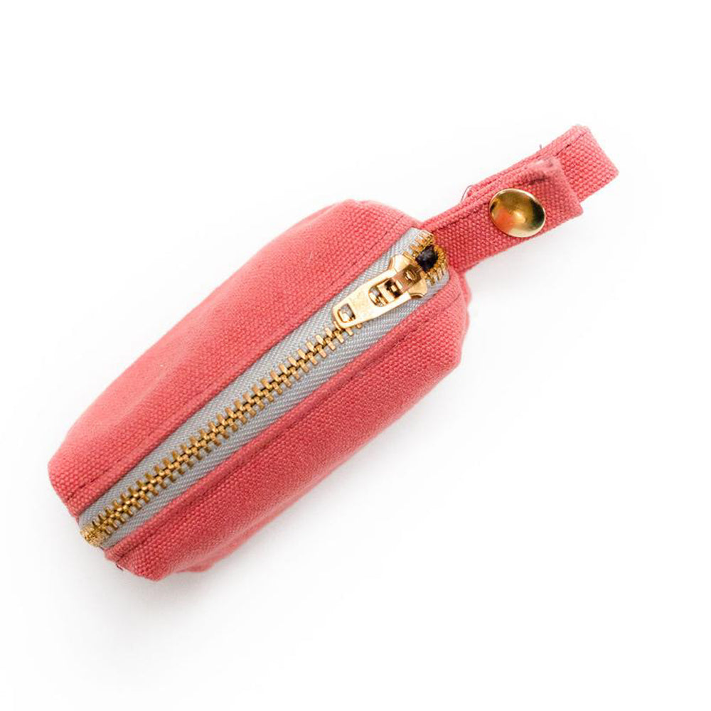 Top  view of fabric rectangular pouch with zip closure and snap loop for poop bags in coral