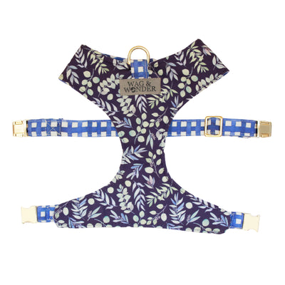 Front view of reversible dog harness with gold hardware in indigo background with mult-color foliage