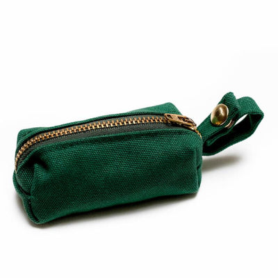 Side view of fabric rectangular pouch with zip closure and snap loop for poop bags in dark green