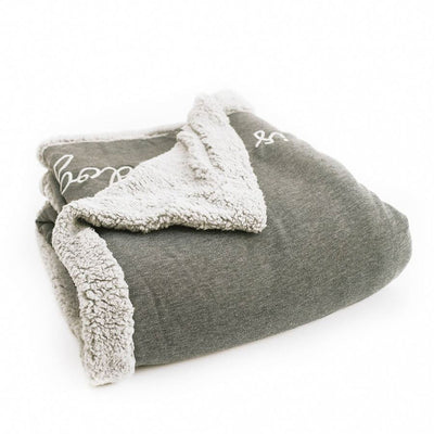 Dark gray Fleece blanket with The Doggy Snuggle is Real embroidered on front and light gray Sherpa back side folded from side