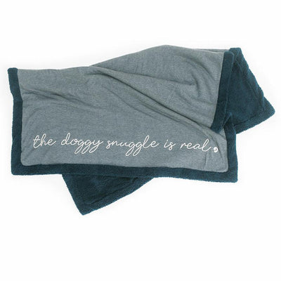 Navy blue Fleece blanket with The Doggy Snuggle is Real embroidered on front and Sherpa back side folded in half