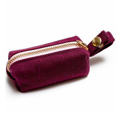 Side view of fabric rectangular pouch with zip closure and snap loop for poop bags in wine
